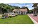 Welcome to Orange Tree: a beautiful community entrance featuring manicured landscaping and stone detailing at 7237 Woodville Cres, Orlando, FL 32819