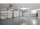 Spacious three car garage with bright lighting and clean floor at 7237 Woodville Cres, Orlando, FL 32819