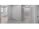 Well-lit hallway with closet and access to the bathroom at 7237 Woodville Cres, Orlando, FL 32819