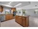 Bright kitchen features stainless steel appliances, granite counters, and wood cabinets at 7237 Woodville Cres, Orlando, FL 32819