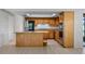 Well-lit kitchen with stainless appliances, granite countertops, an island, and wooden cabinets at 7237 Woodville Cres, Orlando, FL 32819