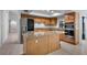 Well-lit kitchen with stainless appliances, granite countertops, an island, and wooden cabinets at 7237 Woodville Cres, Orlando, FL 32819