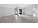 Bright open-concept living room with sliding glass doors, high ceilings, and modern lighting at 7237 Woodville Cres, Orlando, FL 32819