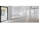 Bright living room featuring a sliding barn door, modern lighting, and white floors at 7237 Woodville Cres, Orlando, FL 32819