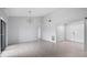 Bright living room featuring a modern lighting, and white floors at 7237 Woodville Cres, Orlando, FL 32819