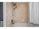 Bathroom shower with tan tile and a shower curtain at 7237 Woodville Cres, Orlando, FL 32819