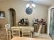 Bright dining area with tile flooring, and a classic chandelier lighting the eating space at 734 La Costa St, Minneola, FL 34715