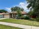 Landscaped home showcasing trimmed bushes and a neatly kept lawn at 734 La Costa St, Minneola, FL 34715