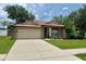 Beautiful home featuring lush landscaping and a spacious driveway, perfect for parking at 734 La Costa St, Minneola, FL 34715