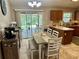 Eat-in kitchen featuring wood cabinets, tile floors, and access to the outdoors at 734 La Costa St, Minneola, FL 34715