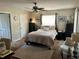Spacious bedroom features a ceiling fan and natural light from the large window at 734 La Costa St, Minneola, FL 34715