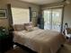 Large bedroom with sliding glass doors leading to outdoor patio and allowing for lots of natural light at 734 La Costa St, Minneola, FL 34715