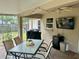 Covered patio with fan, TV, grill, and outdoor dining at 734 La Costa St, Minneola, FL 34715