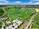 Stunning aerial view of a golf course, lake, and neighborhood homes on a sunny day at 8970 Azalea Sands Ln # 2302, Davenport, FL 33896
