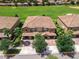 Aerial view of townhomes, manicured lawns, and a verdant golf course creating a desirable neighborhood setting at 8970 Azalea Sands Ln # 2302, Davenport, FL 33896