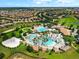 Overhead shows a resort-style pool, sandy volleyball court, and surrounding neighborhood at 8970 Azalea Sands Ln # 2302, Davenport, FL 33896