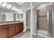 Bathroom featuring dual vanities, a walk-in shower, and separate toilet room at 8970 Azalea Sands Ln # 2302, Davenport, FL 33896