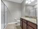 Bathroom with a glass-enclosed shower, granite countertops, and dark wood cabinetry at 8970 Azalea Sands Ln # 2302, Davenport, FL 33896