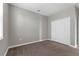 Cozy bedroom featuring neutral decor, carpeting, and a spacious closet with bi-fold doors at 8970 Azalea Sands Ln # 2302, Davenport, FL 33896