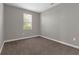 Neutral bedroom with light-gray walls, plush carpeting, and a window providing natural light at 8970 Azalea Sands Ln # 2302, Davenport, FL 33896