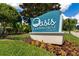 Oasis Clubhouse at Champions Gate sign with lush landscaping in a resort style community at 8970 Azalea Sands Ln # 2302, Davenport, FL 33896