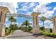 Champions Gate grand entrance features stone pillars, landscaping, and an inviting drive at 8970 Azalea Sands Ln # 2302, Davenport, FL 33896
