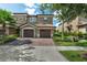 Charming townhome with brick paver driveway, two-car garage, and well-manicured landscaping at 8970 Azalea Sands Ln # 2302, Davenport, FL 33896