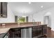 Kitchen featuring granite countertops, stainless steel appliances, and dark wood cabinets at 8970 Azalea Sands Ln # 2302, Davenport, FL 33896