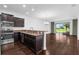 Open concept kitchen and living area featuring dark wood cabinets and stainless steel appliances at 8970 Azalea Sands Ln # 2302, Davenport, FL 33896