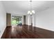 Bright living room with hardwood floors, chandelier, and sliding glass doors to the outside at 8970 Azalea Sands Ln # 2302, Davenport, FL 33896