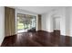Living room with hardwood floors and sliding glass doors leading to a screened-in lanai at 8970 Azalea Sands Ln # 2302, Davenport, FL 33896