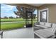 Comfortable screened-in porch offers a tranquil view of the lush green golf course at 8970 Azalea Sands Ln # 2302, Davenport, FL 33896