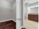 Walk-in closet with hardwood floors leading to bathroom with dual vanities at 8970 Azalea Sands Ln # 2302, Davenport, FL 33896