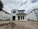 New modern two-story home featuring painted white brick, black trim, and black framed windows at 917 Lake Emerald Dr, Orlando, FL 32806