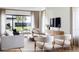 Bright, modern living room with large windows, neutral tones, and stylish decor at 917 Lake Emerald Dr, Orlando, FL 32806
