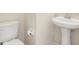 Close-up of a pedestal sink and toilet in the clean, well-lit bathroom at 12449 Cruxbury Dr, Windermere, FL 34786