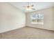 Bright bedroom features neutral walls, plush carpeting, and a ceiling fan at 12449 Cruxbury Dr, Windermere, FL 34786