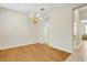 Bright dining room boasts elegant chandelier and leads to hallway at 12449 Cruxbury Dr, Windermere, FL 34786