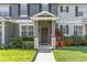 Inviting front entrance features a covered porch, colorful landscaping, and a well-maintained lawn at 12449 Cruxbury Dr, Windermere, FL 34786