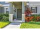 Charming entrance boasting a covered porch, vibrant landscaping, and a meticulously kept lawn at 12449 Cruxbury Dr, Windermere, FL 34786