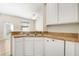 Eat in kitchen featuring white cabinets, neutral countertops, and stainless-steel sink at 12449 Cruxbury Dr, Windermere, FL 34786