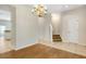 Bright living room with wood flooring, staircase, and elegant chandelier at 12449 Cruxbury Dr, Windermere, FL 34786