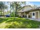 Spacious backyard with mature trees, a patio area, and lush lawn at 14202 Nell Dr, Orlando, FL 32832