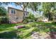 Backyard with mature trees, fire pit, and partially shaded lawn area at 14202 Nell Dr, Orlando, FL 32832