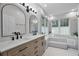 Bright bathroom with double vanities, tub, and large windows offering plenty of natural light at 14202 Nell Dr, Orlando, FL 32832