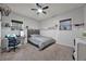 This cozy bedroom is complete with a desk, decor, and a lighted ceiling fan at 14202 Nell Dr, Orlando, FL 32832