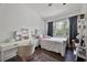 Bedroom featuring wood floor, large window and ceiling fan at 14202 Nell Dr, Orlando, FL 32832