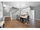 Spacious dining room with hardwood floors, chandelier, and stairs to the second floor at 14202 Nell Dr, Orlando, FL 32832