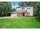 Charming two-story home with a well-manicured lawn, attached garage, and front porch perfect for relaxing outdoors at 14202 Nell Dr, Orlando, FL 32832