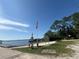Scenic waterfront view featuring a pier, the American flag, and recreational watercraft at 14202 Nell Dr, Orlando, FL 32832